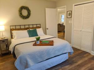 a bedroom with a bed with a wooden tray on it at Gold Dust Delight - Cozy Cottage In The Woods in Dahlonega