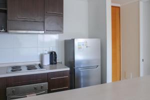 a kitchen with a stainless steel refrigerator and a stove at Condominio Vista Azapa Piso 2 Dto 24 in Arica