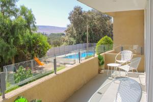 a balcony with chairs and a swimming pool at Condominio Vista Azapa Piso 2 Dto 24 in Arica
