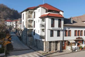 a white building on the side of a street at Бялата Къща 2 in Zlatograd