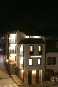 a white building with lights on it at night at Бялата Къща 2 in Zlatograd