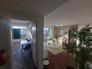 a living room with a table and a living room at Horizon Dream in Funchal