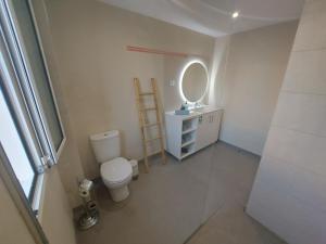 a bathroom with a toilet and a mirror at Horizon Dream in Funchal +39 photos
