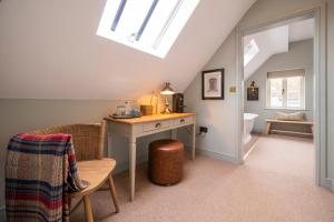 a attic room with a desk and a toilet at The Bottle & Glass Inn - Deluxe Room - Room 3 in Henley on Thames