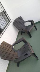 two wooden benches sitting next to each other at Departamento en Recoleta con Balcon Terraza in Buenos Aires