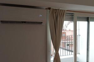 a room with a window with a curtain at Departamento en Recoleta con Balcon Terraza in Buenos Aires
