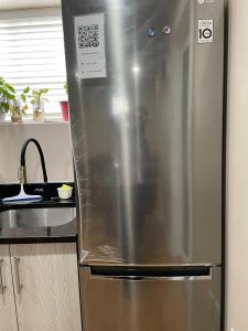 a stainless steel refrigerator in a kitchen at Super Luxury & Cozy Lower Level Apartment in NW Calgary, AB Close to Banff in Calgary