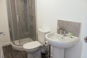 a bathroom with a toilet and a sink and a shower at 1Bed Apartment in Heywood with Transport Links in Heywood