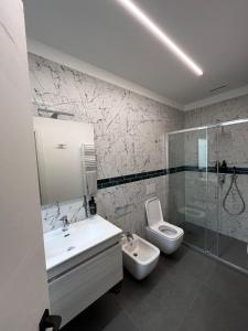 a bathroom with a sink and a toilet and a shower at B&B A due passi dal mare in Lido di Pomposa