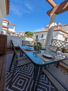 a blue table with chairs on a balcony at APARTAMENTO EN COTO DE SANCTI PETRI in Chiclana de la Frontera