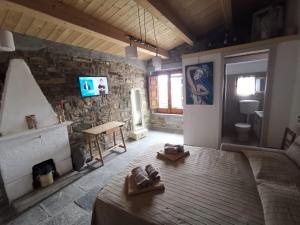 a bedroom with a bed and a stone wall at Sant'Elia B&B in Alessandria del Carretto
