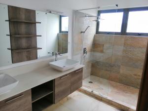 a bathroom with a sink and a shower at Faro Villa in Centre de Flacq