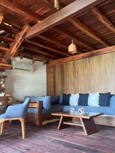 a living room with a blue couch and a table at El Paraiso Hotel Tulum in Tulum