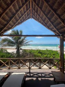 a view of the beach from the porch of a resort at El Paraiso Hotel Tulum in Tulum
