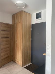 Habitación con armario y armario de madera. en Apartament Daszyńskiego, en Suwałki