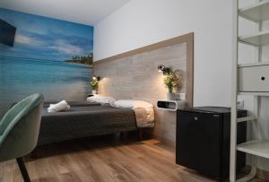 Postel nebo postele na pokoji v ubytování Hotel Ridomar 365