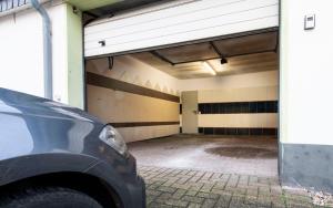 a parking garage with a car parked in it at Stay and Work Apartment - 8 single beds - Garage in Bedburg Hau