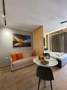 a living room with a couch and a table at Ralph Apartments in Vlorë