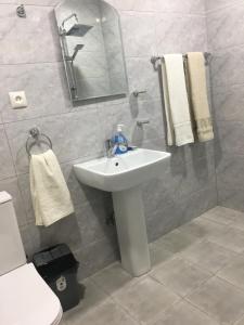 a bathroom with a sink and a mirror and a toilet at Bardy guest house in Chʼiva