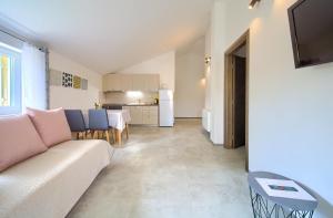 a living room with a couch and a table at Apartmani DAL in Malinska