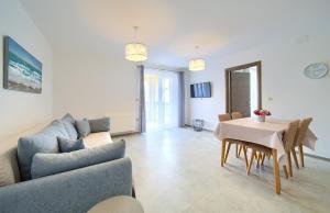 a living room with a couch and a table at Apartmani DAL in Malinska