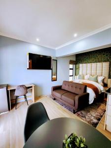 a hotel room with a bed and a couch at 136 on 4th in Johannesburg