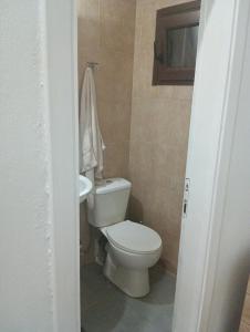 a bathroom with a white toilet and a sink at Studio Jim in Volos