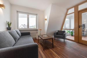 a living room with a couch and a chair at Bike- und Ferienhotel Freiburg in Freiburg im Breisgau