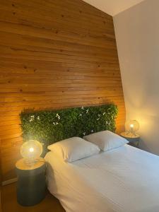 萊克朗蘭比塞特爾的住宿－Superbe et accuiellent appartement，一间卧室配有一张带两盏灯的大型白色床。
