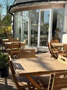 a wooden picnic table and chairs on a patio at Pensjonat Jagoda B&B in Międzyzdroje