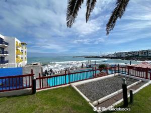 a view of the beach from the balcony of a resort at Mandy's kaliva Club Mykonos in Langebaan +2 photos