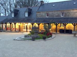 
a large stone building with a fountain in front of it at Auberge De Kerveoc'h in Douarnenez
