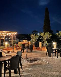a patio with tables and chairs at night at Argentiere Room Apartments in Florence