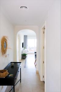 a living room with white walls and a black table at Casa Jilou in Mijas Costa +35 photos