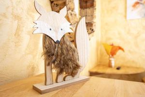a wooden statue of a fox on top of a table at La Bonne Auberge in Saint-Martin-Vésubie