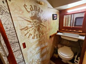 a bathroom with a toilet and a wall covered in graffiti at Lanzarote Pirat in Arrecife