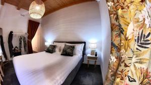 a bedroom with a large white bed in a room at Deodato Apartments in Tropea