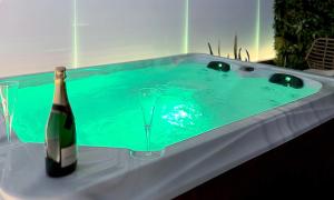 a bottle of champagne and a glass in a tub at Rodosrooms in Rhodes Town +35 photos