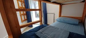 a small bedroom with a bed and a window at La Casa di Chicca in Camigliatello Silano