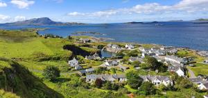 a village on a hill next to a body of water at Number 10, Isle of Luing in Cullipool