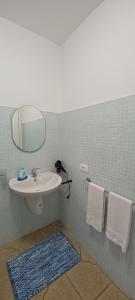 a bathroom with a sink and a mirror and towels at La Casa di Chicca in Camigliatello Silano