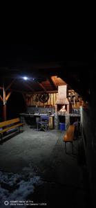 a dark room with benches and a fire place at La Butuci in Târgu Ocna