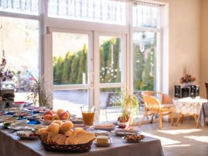 a table with food on it in a living room at Willa Bliska in Gdańsk