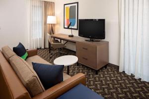 a hotel room with a couch and a desk with a television at Residence Inn Sunnyvale Silicon Valley I in Sunnyvale