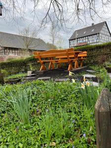 a wooden bench sitting in the middle of a garden at Fachwerk in Bergfreiheit in Bad Wildungen
