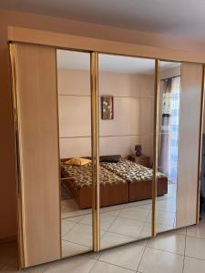 a bedroom with a bed through a sliding glass door at Bungalow am Meer in Grzybowo
