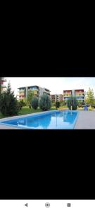 a large swimming pool in front of a building at Star Airport Residence in Otopeni