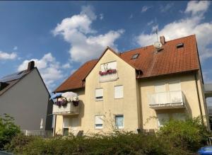dom z budkami kwiatowymi na oknach w obiekcie Complete Apartment peacefully situated near the Airport Nürnberg w Norymberdze