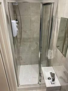 a bathroom with a shower and a sink at Studio close to Camden in London