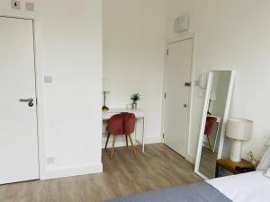 a bedroom with a bed and a desk and a table at Studio close to Camden in London